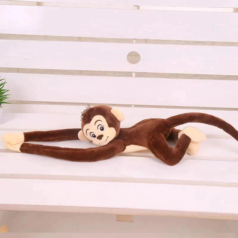 Peluche singe qui s'accroche